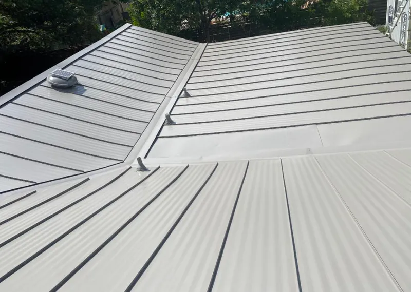 Solar attic fan installed on a metal roof for Roof Ventilation in Gladstone